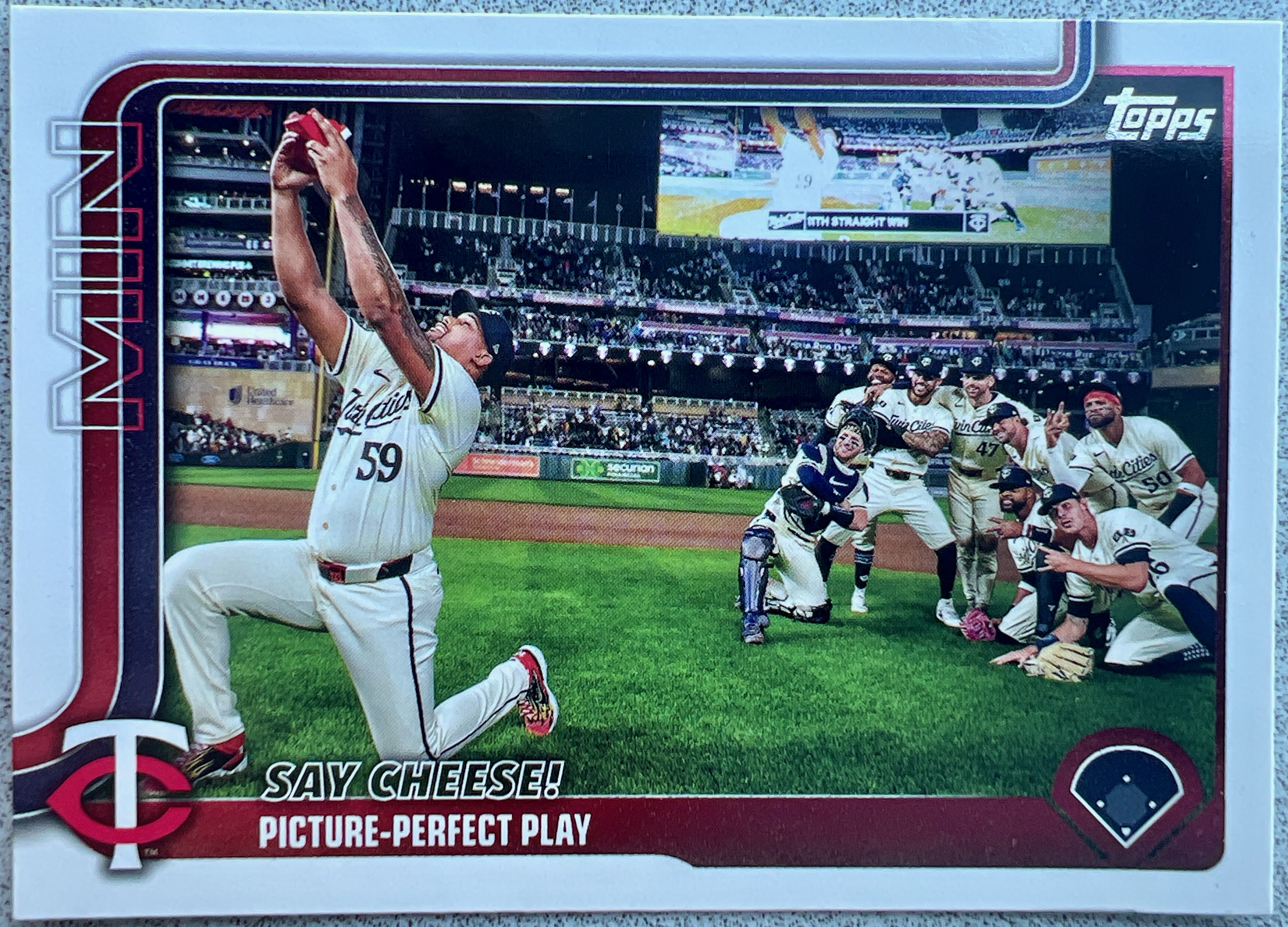 Image of a Topps baseball card of Twins taking their own selfie after a win